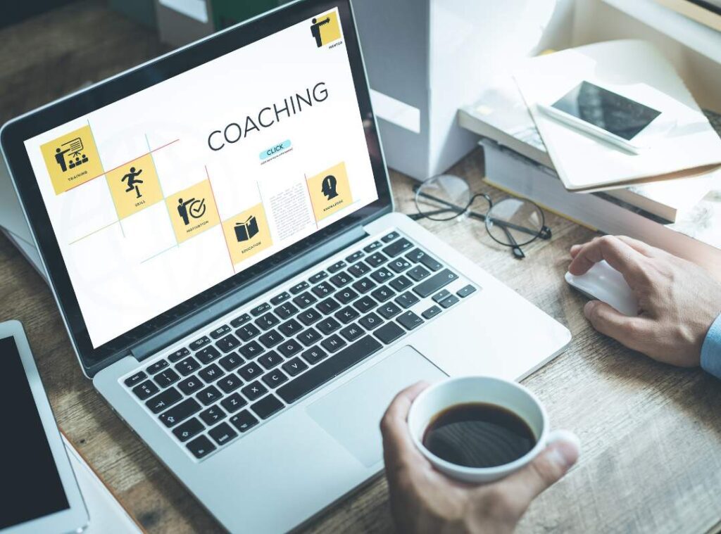 A laptop with a "coaching" displayed on screen.